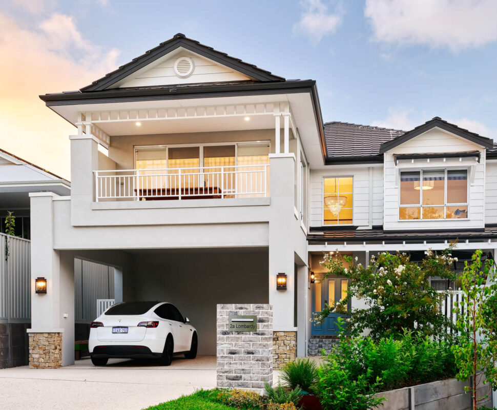 Two-storey custom home on Lombardy Street featuring traditional architectural detailing, weatherboard cladding and a covered balcony.