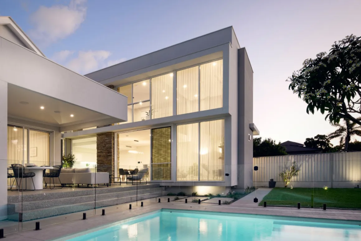 Two-storey custom home featuring expansive glazing, a swimming pool and outdoor entertaining areas.