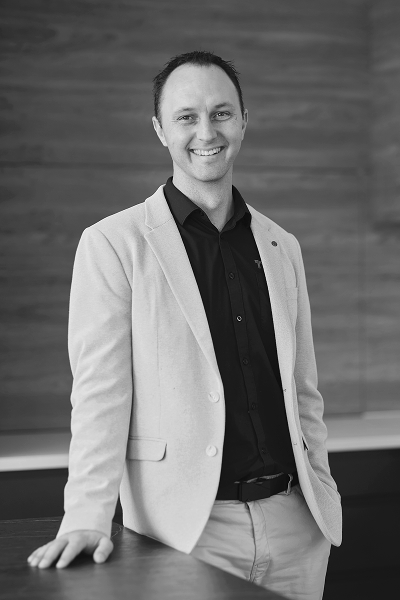 Black-and-white professional portrait of Colin Te Braake, Lead Designer at Trendsetter Homes.