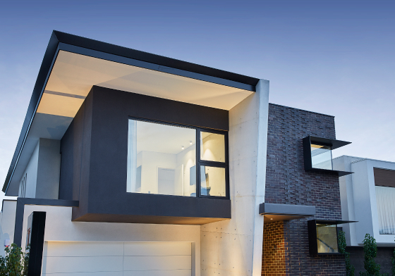 Contemporary custom home at Redmond Street featuring dark exterior cladding, large windows and contrasting facade materials.