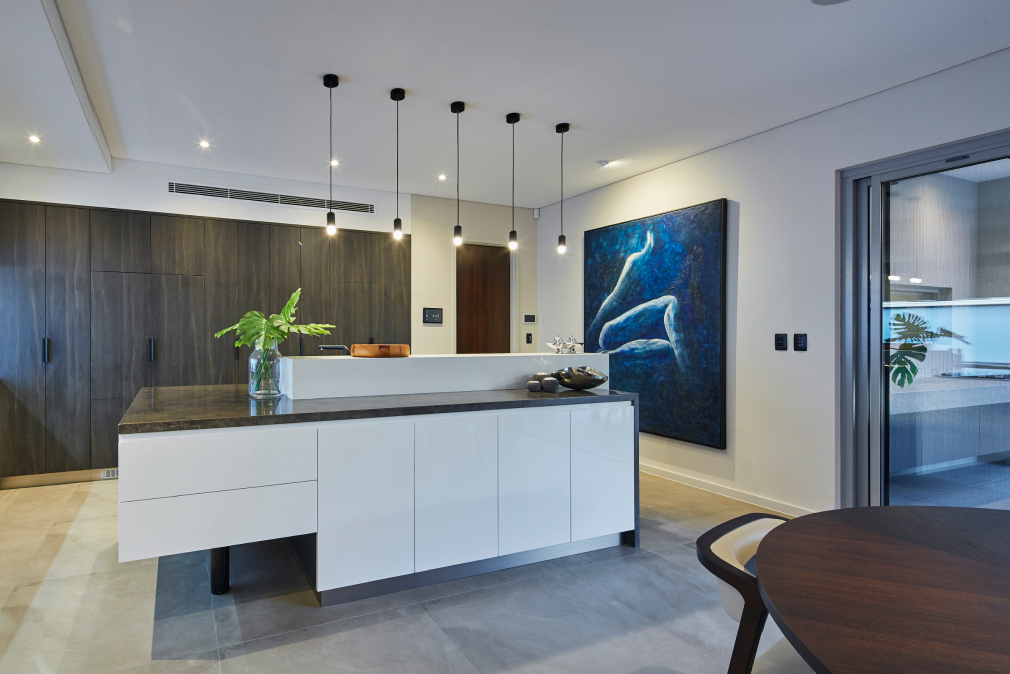 Custom home kitchen featuring a freestanding island bench, pendant lighting and contrasting cabinetry.