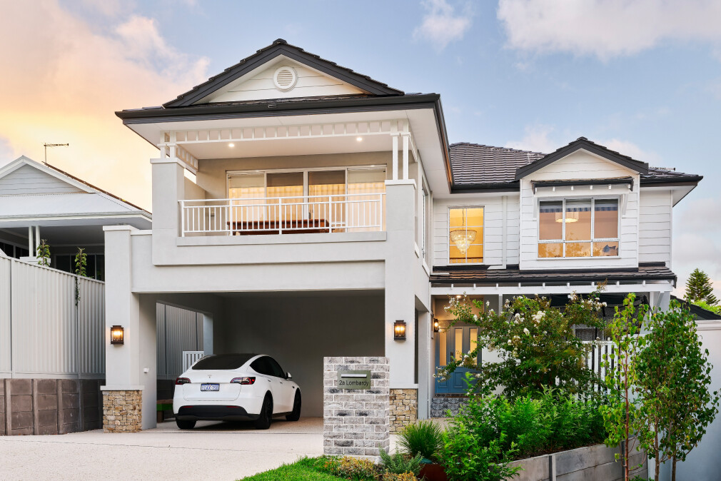 Two-storey custom home on Lombardy Street featuring traditional architectural detailing, weatherboard cladding and a covered balcony.