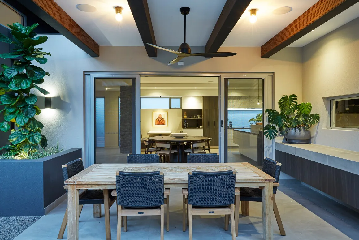 Dining area featuring large sliding glass doors, timber ceiling detailing and a connection to outdoor entertaining.