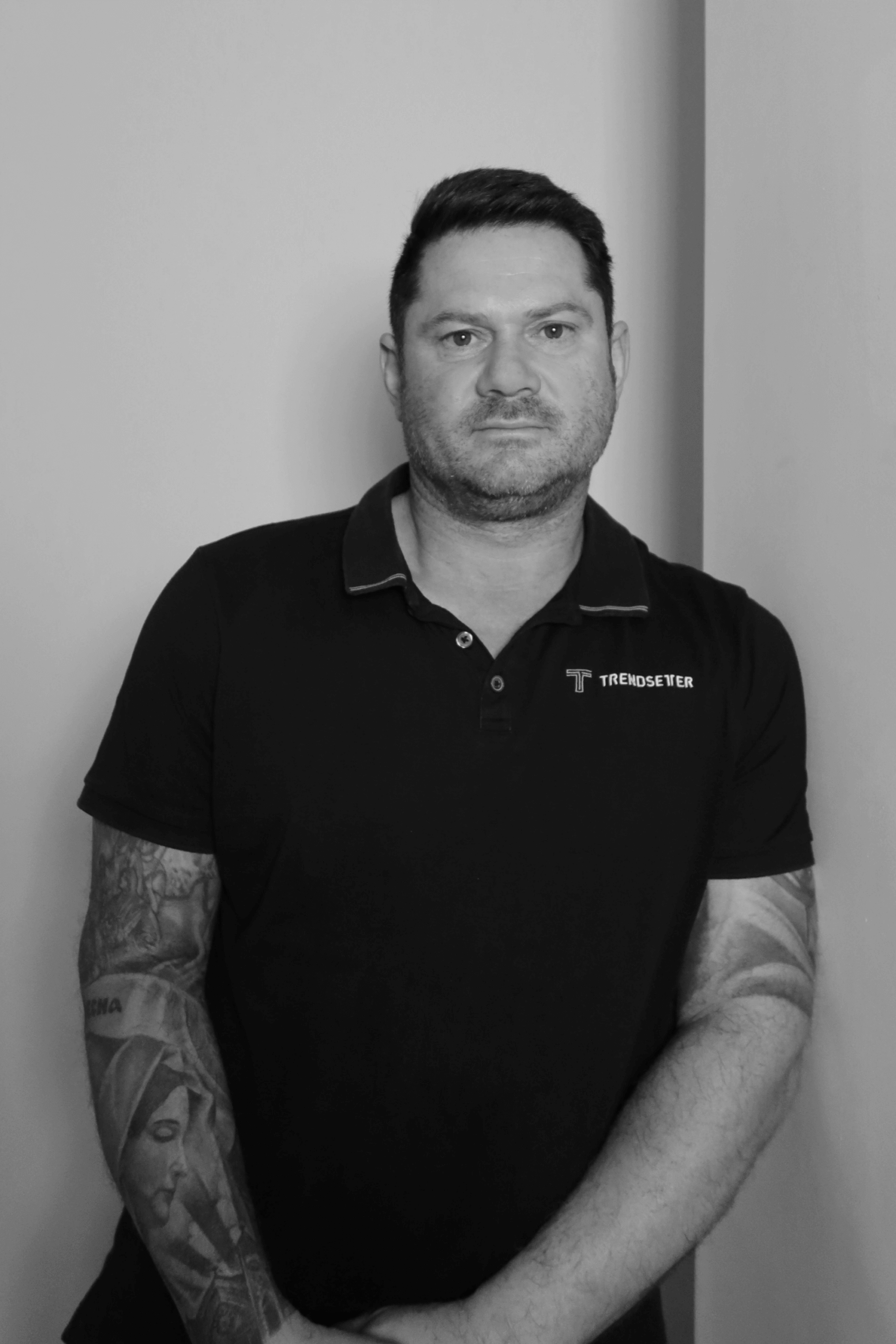 Black-and-white professional portrait of Project Manager, Louie Kajmakoski from the Trendsetter Homes team.