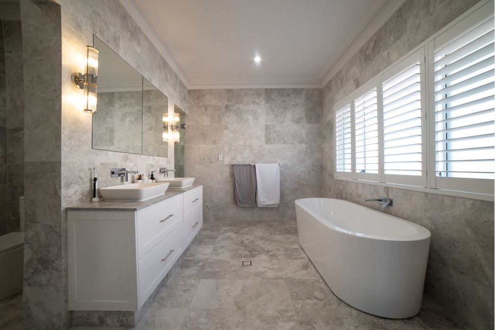 A large custom bathroom with marble details and a relaxing neutral colour scheme in Perth