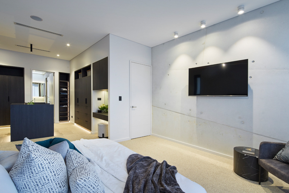 Open-plan living area featuring white walls, tiled flooring and contemporary furnishings at the Redmond Street custom home.
