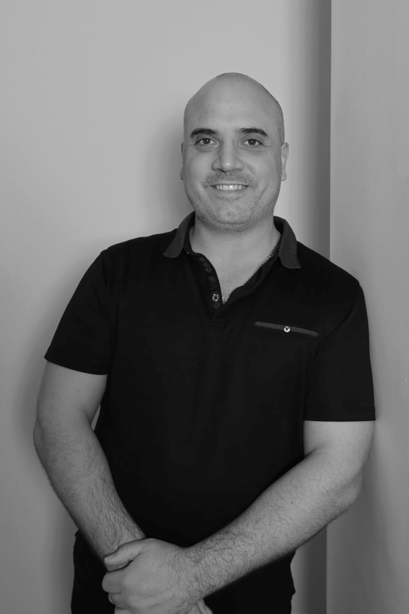 Black-and-white professional portrait of Senior Estimator, Andrew Carbone from the Trendsetter Homes team.