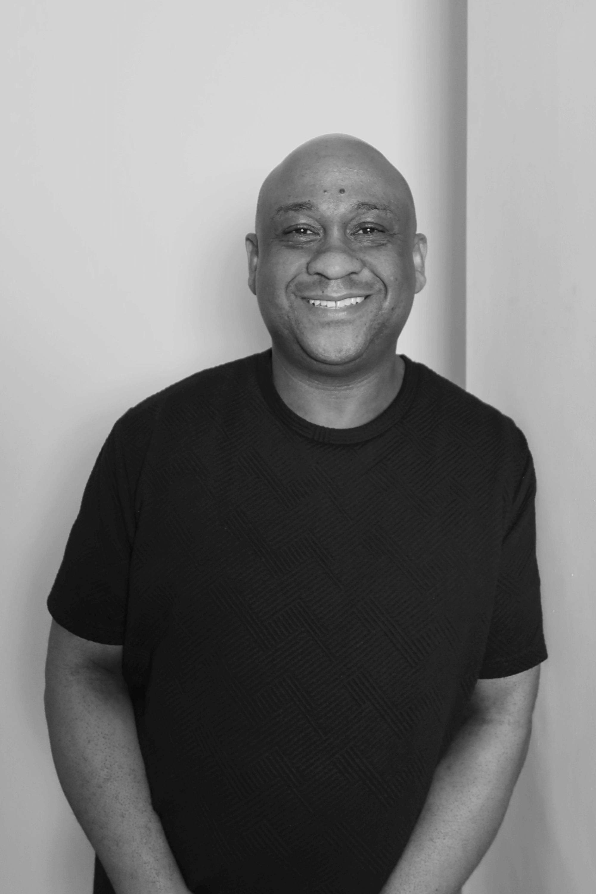 Black-and-white professional portrait of Scheduling Manager, Keenan Joseph from the Trendsetter Homes team.