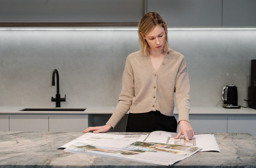 Woman reviewing custom home plans by Perth bespoke home builder Trendsetter Homes