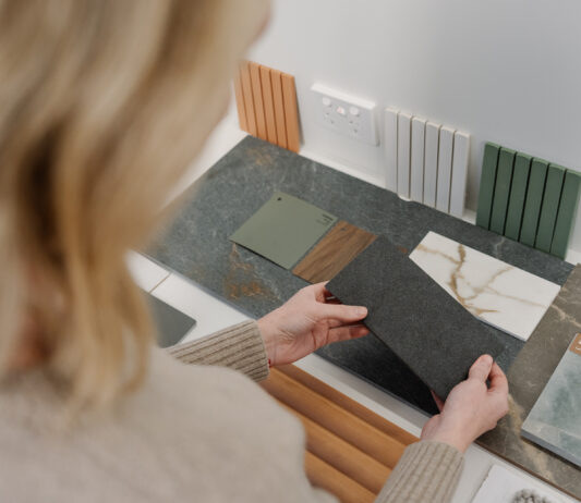 Woman selecting different colours for her custom home to avoid any common home building mistakes