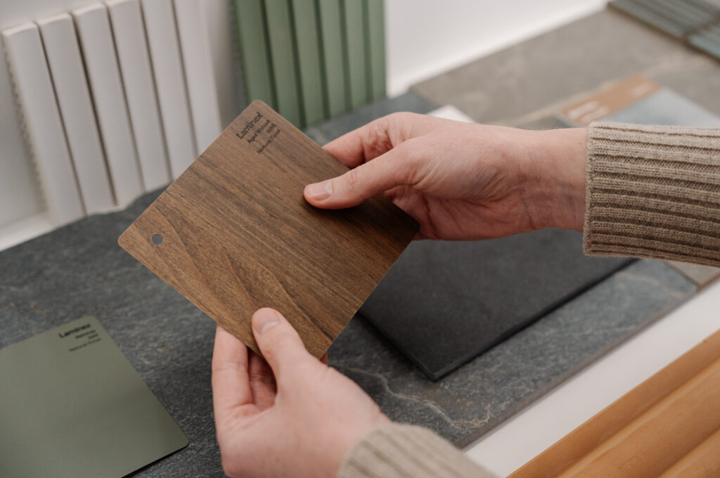 Trendsetter Homes client selecting a wooden material for her custom home journey step 4