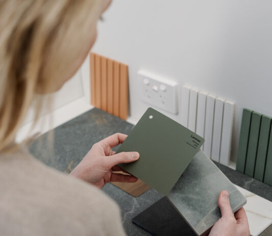 Designer reviewing material and colour samples for a custom home interior.
