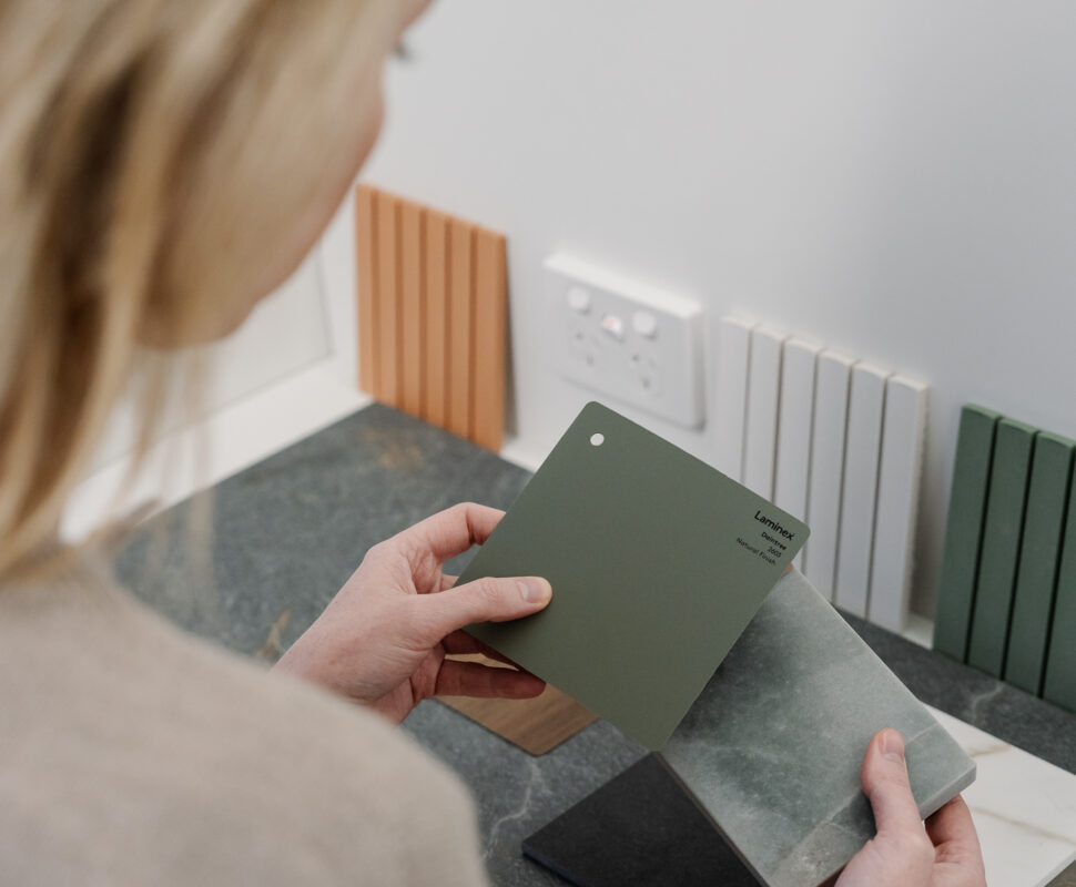 Designer reviewing material and colour samples for a custom home interior.