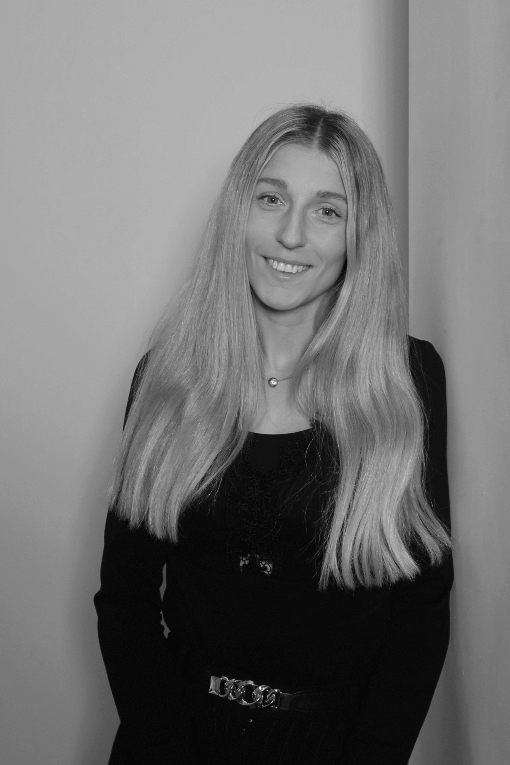 Black-and-white professional portrait of Trust Assistant Janina Groeger from the Trendsetter Homes team.