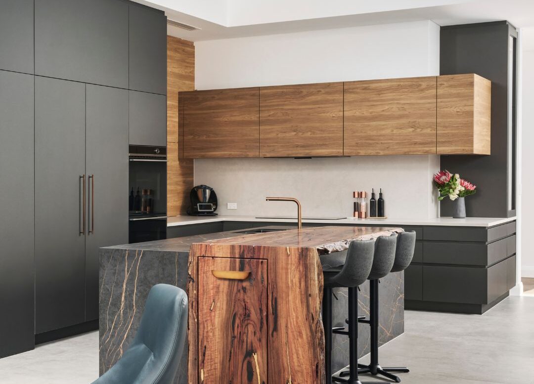 Contemporary kitchen featuring timber cabinetry, stone benchtops and a large island with seating.