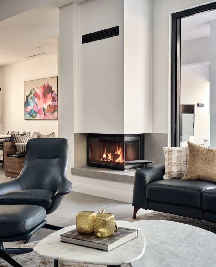 Custom home living area featuring a built-in fireplace, contemporary artwork and comfortable seating.