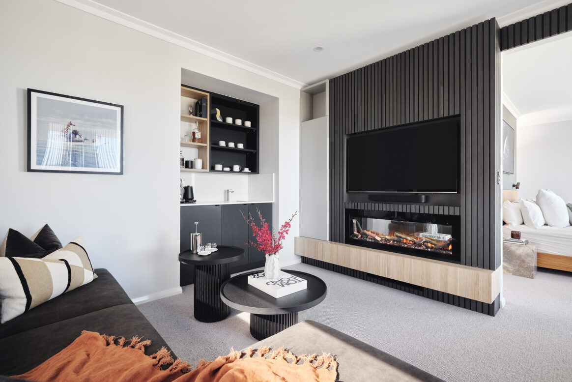 Custom home living room featuring dark timber wall panelling, built-in entertainment cabinetry and contemporary furnishings.