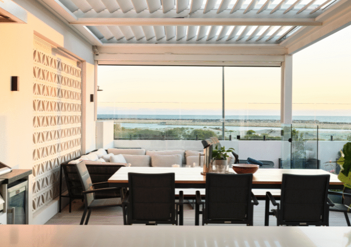 Covered alfresco area featuring outdoor dining furniture, timber ceiling detailing and uninterrupted ocean views.