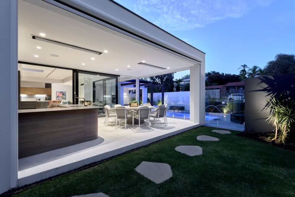 Contemporary custom home featuring an outdoor entertaining area, expansive glazing and modern architectural detailing.