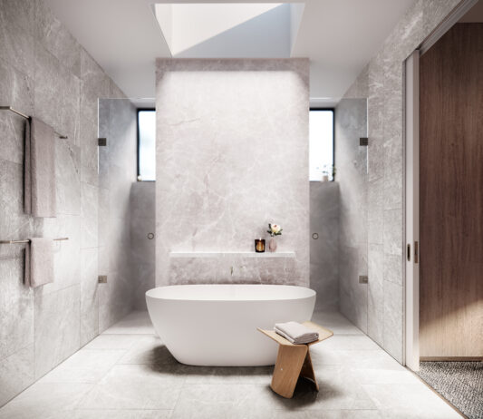 Architectural render of a bathroom featuring natural stone finishes, freestanding bath and warm lighting.
