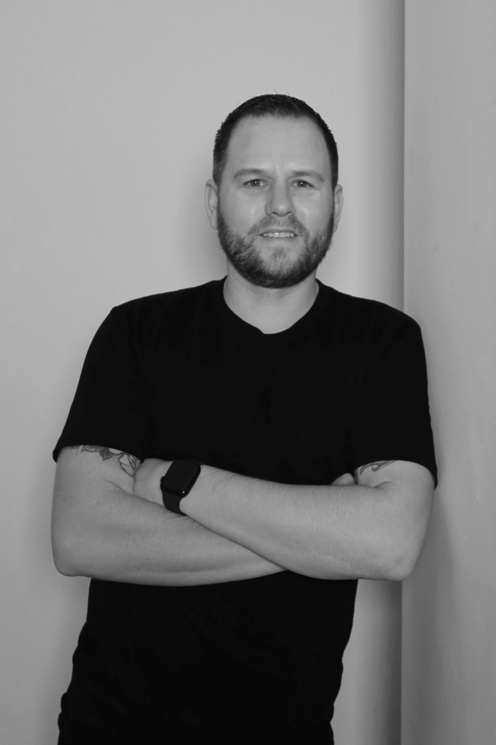Black-and-white professional portrait of Chief Financial Officer, Andrew Wallace from the Trendsetter Homes team.