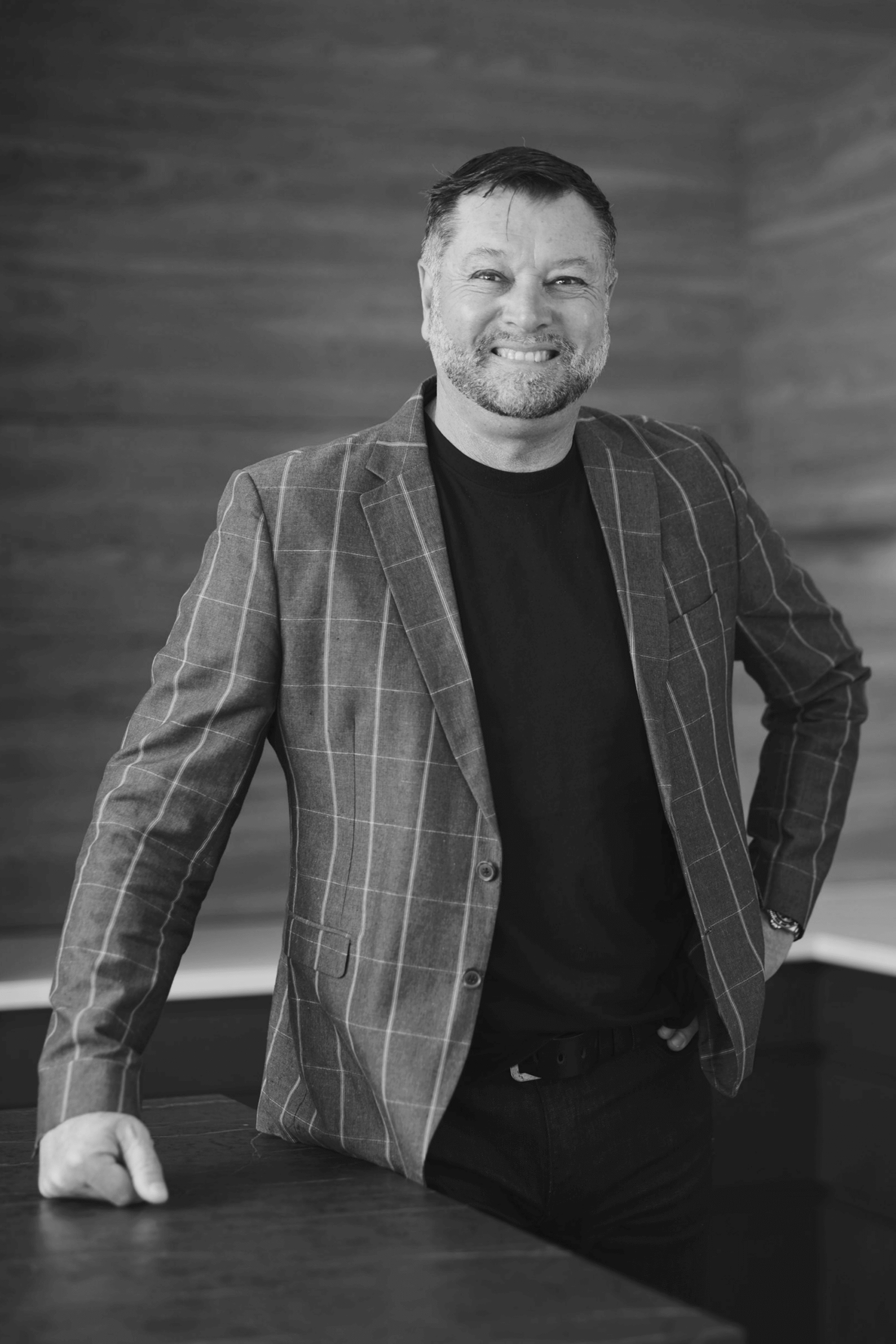 Black-and-white professional portrait of Marek Rodkiewicz, Design & Build Consultant at Trendsetter Homes.