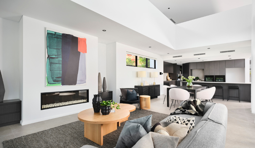 Contemporary living and dining space in an Ardross custom home featuring dark cabinetry, stone finishes and modern furniture.