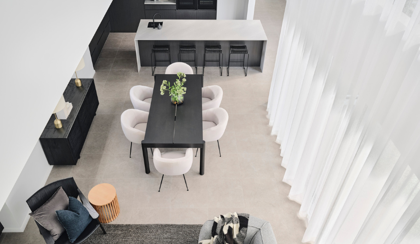 Double-height void overlooking the dining area in an Ardross custom home, featuring modern furniture and natural light.