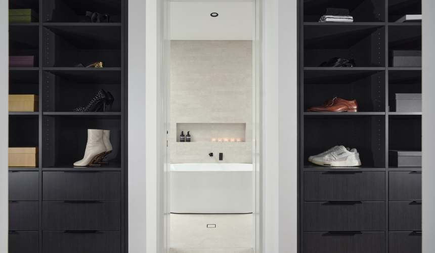 Walk-in robe in an Ardross custom home featuring custom cabinetry, integrated shelving and contemporary finishes.