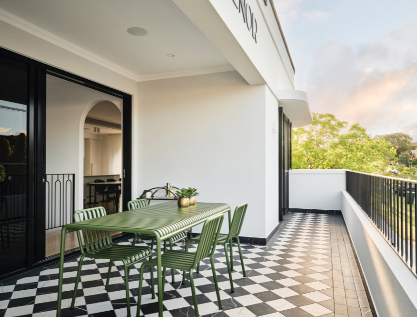 Grosvenor custom home in Mount Lawley featuring Art Deco-inspired curved architecture, a covered balcony and distinctive architectural detailing.
