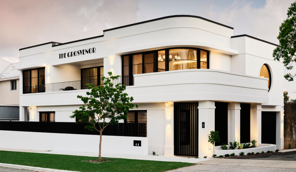 Art-Deco custom home exterior in Mount Lawley featuring curved white walls, horizontal rooflines and large windows.