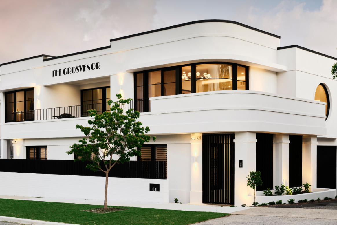 Art-Deco custom home exterior in Mount Lawley featuring curved white walls, horizontal rooflines and large windows.