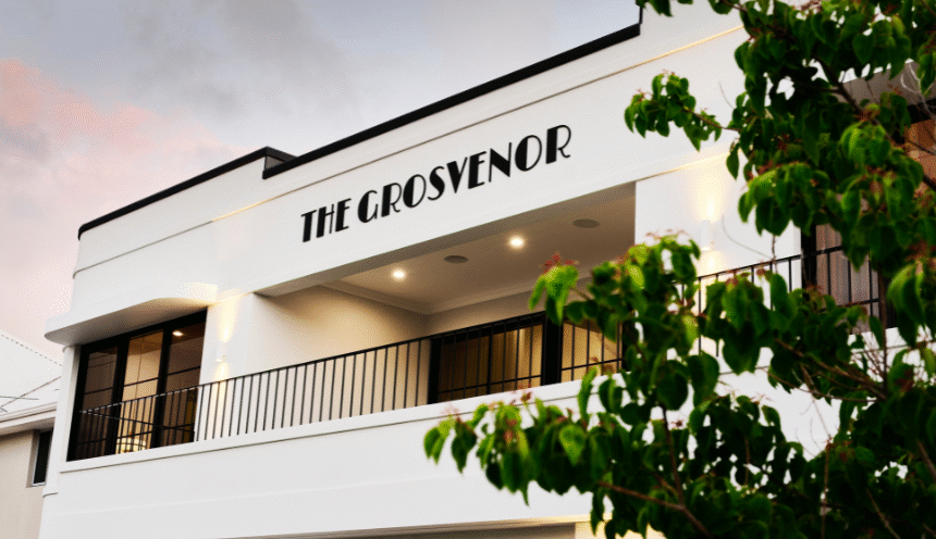 Exterior architectural detail of the Grosvenor custom home featuring curved white walls and the home's name.