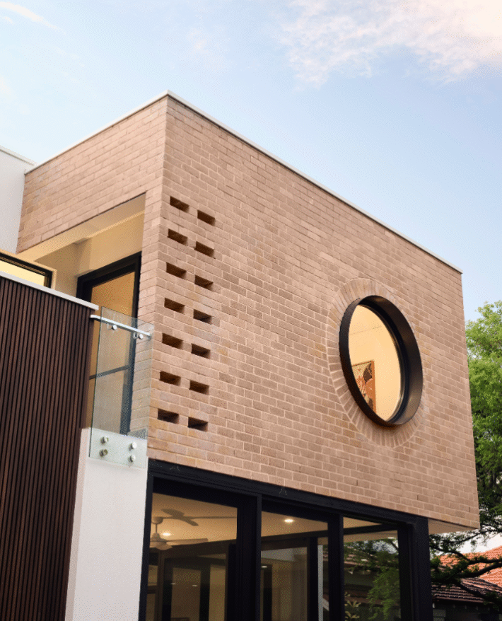 Architectural detail of a circular window and feature brickwork at a contemporary Nedlands custom home.