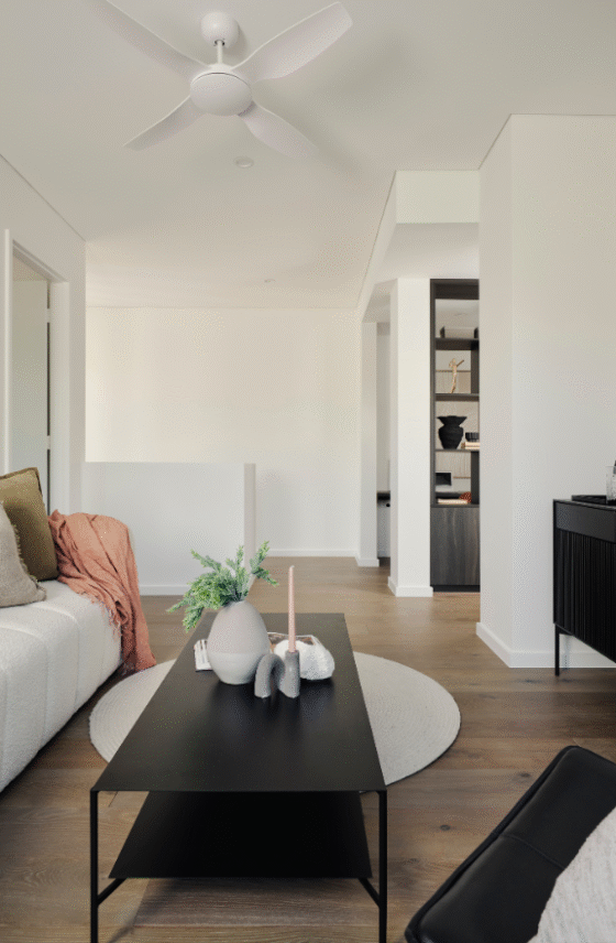 Light-filled sitting nook in a Nedlands custom home featuring soft furnishings, white walls and timber flooring.