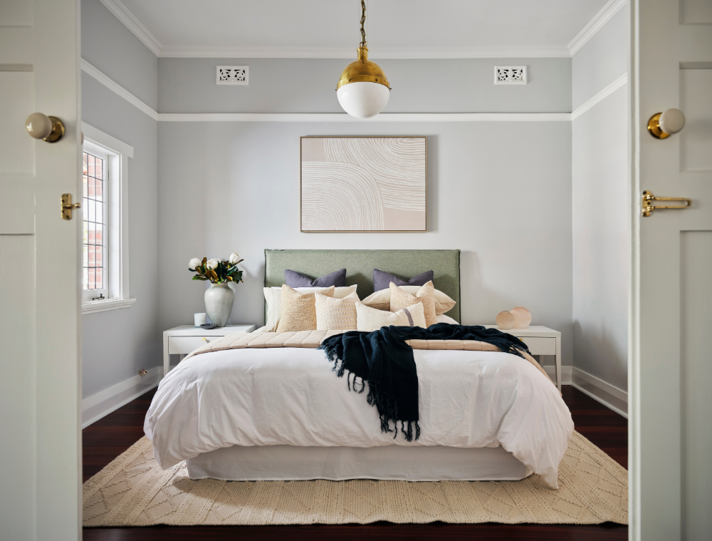 Elegant bedroom with decorative wall panelling, pendant lighting and soft furnishings in a renovated Mount Lawley home.