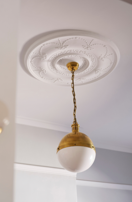 Decorative ceiling rose with a suspended brass pendant light in a renovated Mount Lawley home.