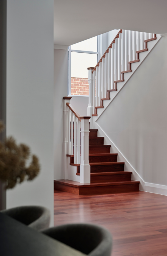 Timber staircase with white balustrade and natural light in a renovated character home in Mount Lawley.